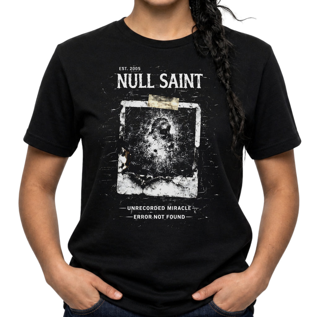 Null Saint archive graphic tee featuring distressed white typography, corrupted photo artwork, and dark underground grunge styling on a black T-shirt.