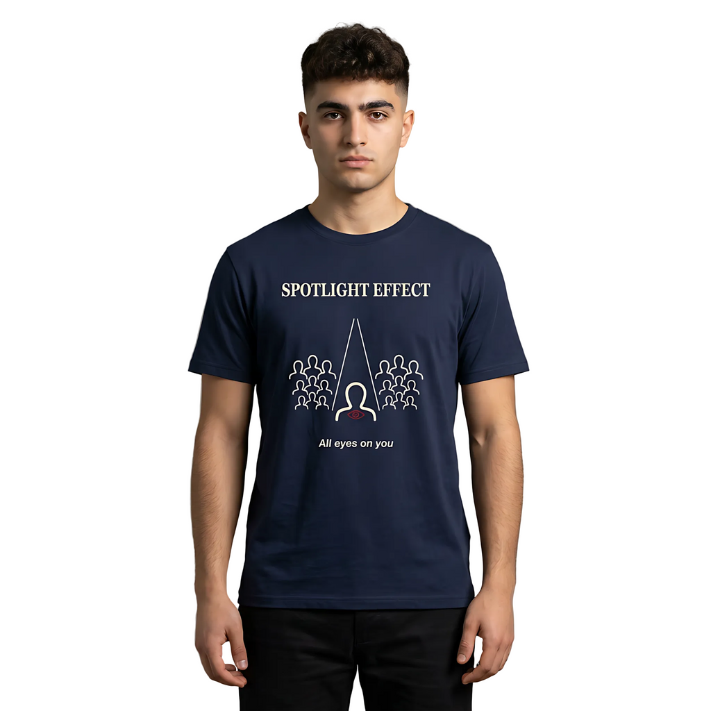 Person wearing a navy blue t-shirt with 'Spotlight Effect' design on a gray background