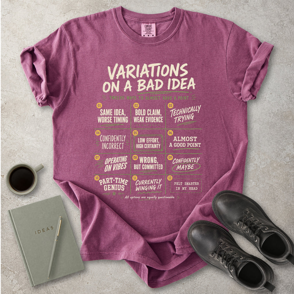 Berry red Comfort Colors graphic T-shirt with Variations On A Bad Idea decision chart design, styled with coffee, notebook, pen and black boots