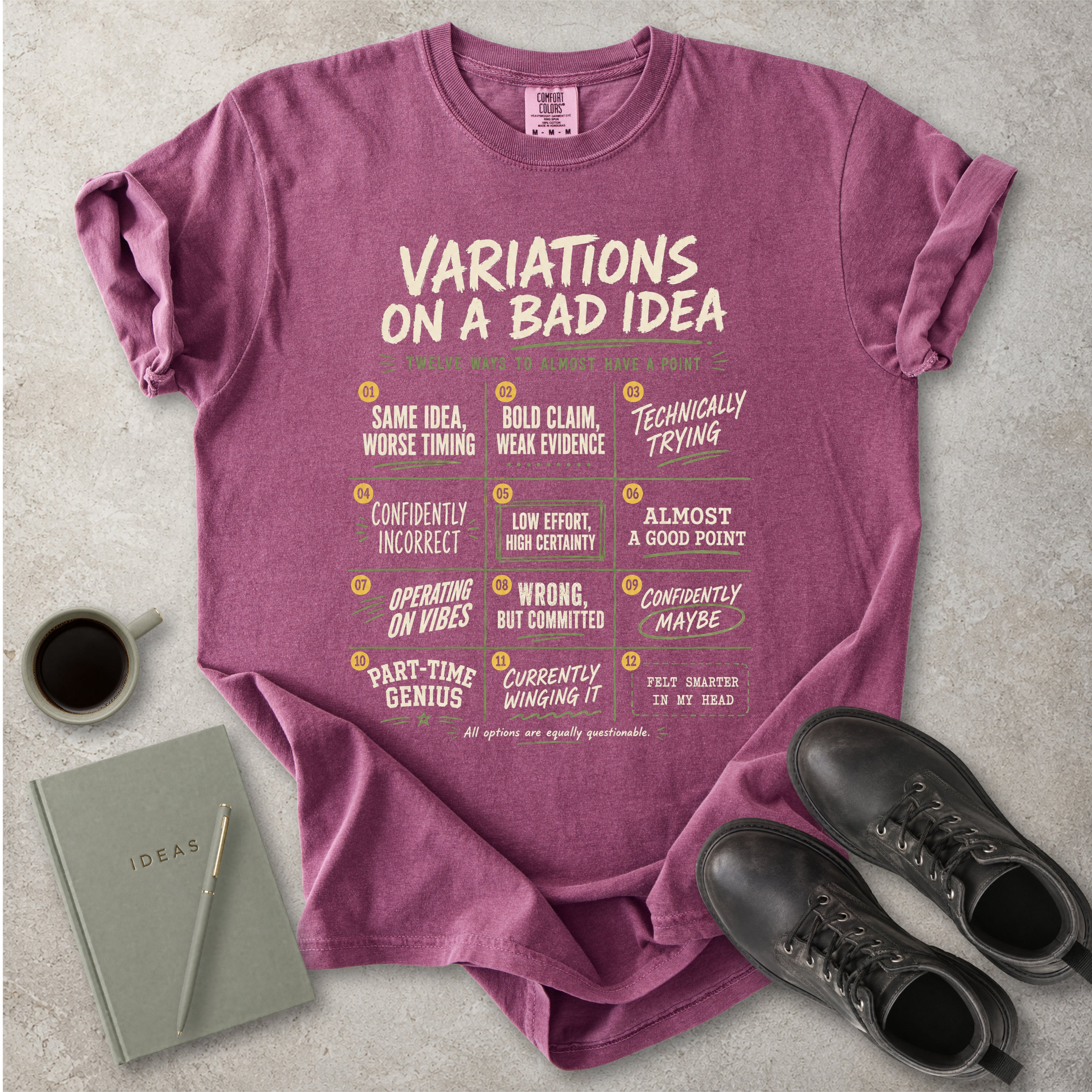 Berry red Comfort Colors graphic T-shirt with Variations On A Bad Idea decision chart design, styled with coffee, notebook, pen and black boots