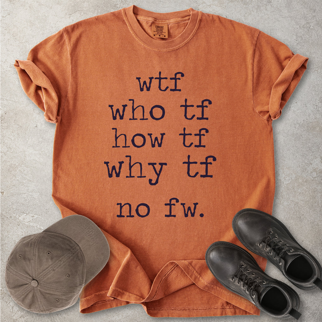 Orange Comfort Colors graphic T-shirt with grey text reading wtf, who tf, how tf, why tf and no fw, styled with a brown cap and black boots